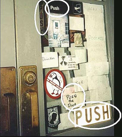 Photo of a door covered in signs that say Push.